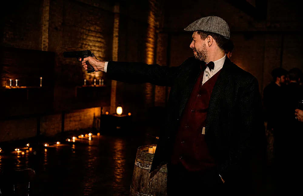 Guests do indoor shooting with Colt 1911 airsoft replicas at the Peaky Blinders Black Penny Society event